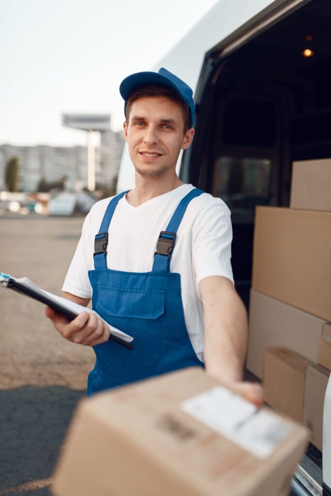 deliveryman-in-uniform-gives-parcel-delivery-NLBP7VP-1